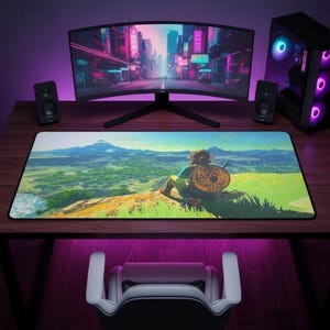 May include: A rectangular desk mat featuring a vibrant, high-resolution landscape illustration of a character sitting on a cliff edge overlooking a vast green valley with a distant mountain, complete with a circular shield design on the character's back.