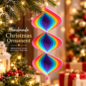 May include: A spiral-shaped crochet ornament featuring a vibrant rainbow gradient of pink, orange, yellow, green, blue, and purple yarn. The hanging decoration includes a small wooden bead at the top and displays the text Handmade Christmas Ornament.