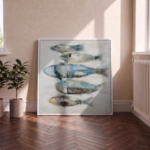 May include: A square framed wall art piece featuring a horizontal composition of five stylised fish stacked vertically. The fish are rendered in shades of blue, grey, beige, and white with visible brushstrokes and a textured, layered paint application.