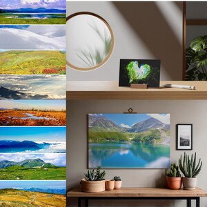 以下が含まれることがあります： 部屋に飾られた風景写真プリントのコレクション。1枚はハート型の洞窟の入り口、もう1枚の大きな横長のプリントは山頂を映し出す山岳湖を描いています。鉢植えの多肉植物と丸い鏡が含まれています。