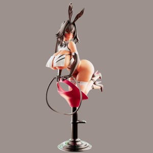 May include: A stylized anime-style figurine of a character with dark hair and long rabbit ears, wearing a white and black outfit with gloves and high heels. The character is posed sitting on a red seat atop a black pedestal, holding a circular hoop.
