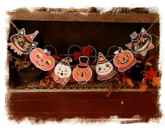 May include: A Halloween-themed banner featuring vintage-style cutouts of black cats, pumpkins, and other festive characters. The banner is strung on twine and decorated with fall foliage, creating a charming and spooky seasonal decoration.