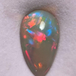 Natural Dark Base Ethiopian Opal Cabochon Pear Shape 18.55 Carat Weight Multi Fire Dark Base Opal 26x15x10 mm size Opal Cabochon