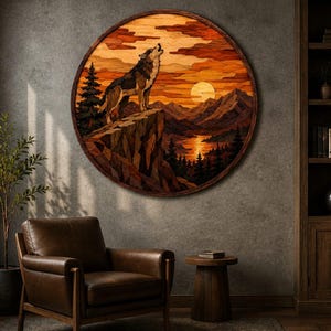 May include: A circular wooden wall art piece featuring a multi-layered inlay design of a wolf howling on a cliffside. The scene depicts a sunset over mountains, a lake, and pine trees, rendered in various shades of brown, orange, and tan wood.