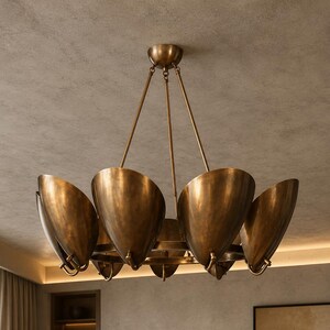 May include: A circular chandelier featuring a series of bowl-shaped metal shades with a brushed antique brass finish. The fixture is suspended by thin metal rods connected to a central canopy, creating a symmetrical arrangement of curved light reflectors.