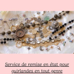 May include: A collection of assorted jewelry pieces including gold-tone chains, black beaded strands, a compass pendant, a lion head charm, moon and star motifs, and small ceramic bird accents. The text NOVECLAT, Service de remise en état pour guirlandes en tout genre, démêlage, nettoyage, tri par catégorie is visible.