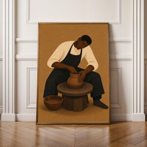 May include: A framed wall art print depicting a person with dark skin wearing a cream-colored long-sleeve shirt and a black apron, sitting and shaping a clay pot on a pottery wheel. A small brown bowl sits on the floor next to the wheel.