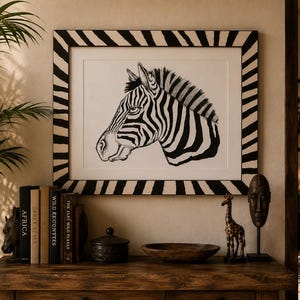 May include: A framed black and white illustration of a zebra head centered on a white background. The frame features a bold, repeating black and white striped pattern that radiates outward from the central artwork, creating a cohesive visual border.
