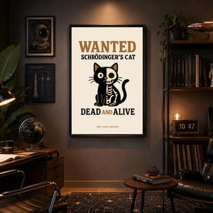 May include: A rectangular wall poster with a cream background featuring the text WANTED SCHRÖDINGER'S CAT DEAD AND ALIVE in black and brown. The central graphic depicts a black cat with one half showing its skeleton in white and black.