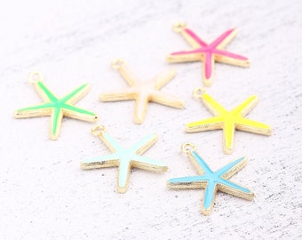 Pode incluir: Seis pingentes de estrela-do-mar coloridos com bordas douradas. Os pingentes são em tons de rosa, amarelo, verde, azul claro e creme. Cada estrela-do-mar tem um pequeno laço na parte superior para prender a joias ou outros trabalhos manuais.