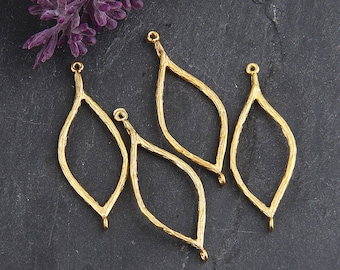 May include: Four gold leaf-shaped metal jewelry findings with a hammered texture. Each finding has a loop at the top and bottom.