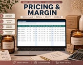 A laptop displays a "Pricing & Margin" spreadsheet, with two candles, a calculator, and a notebook on a wooden desk.