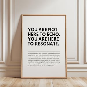 May include: A rectangular framed wall art print featuring black text on a white background. The bold headline reads: YOU ARE NOT HERE TO ECHO. YOU ARE HERE TO RESONATE. Below this, a paragraph of smaller text expands on the theme of authenticity.