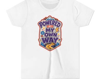 May include: A white short-sleeved t-shirt featuring a central graphic design with the text "POWERED BY MY OWN WAY" in purple letters. The illustration includes a winding yellow road, a blue mountain peak, a yellow lightning bolt, and gears.