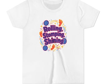 May include: A white short-sleeved t-shirt featuring a central graphic with the purple text Rolling, Stomping, Shining. The design includes orange footprints, blue circular wheel icons, and yellow star accents arranged in a circular pattern.