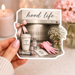 May include: A sticker featuring a laminar flow hood with the text hood life, a pink bow, a coffee cup labeled coffee & sterility, a syringe, two vials, an alcohol prep pad, pink gloves, and a small glass vase filled with baby's breath flowers.