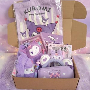 May include: A cardboard box filled with Kuromi-themed merchandise including a purple tote bag with the text Kuromi Every day is good, a plush toy, a fuzzy headband with ears, a purple pencil case with a Kuromi graphic, and a multi-coloured pen.