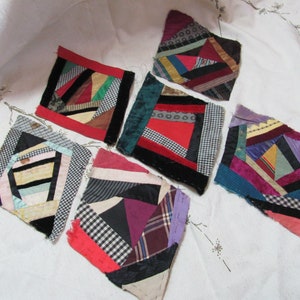 May include: Six colorful patchwork quilt squares made from scraps of fabric in various patterns and colors, including red, black, white, green, blue, and purple.