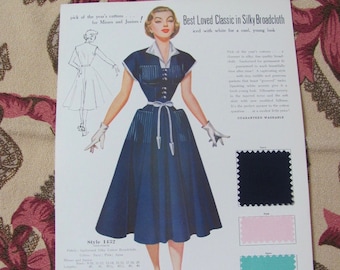 May include: A vintage advertisement for a blue dress made of silky broadcloth. The dress has a white collar, white buttons, and a white belt. The ad features a model wearing the dress and a color swatch of the fabric. The text reads "Best Loved Classic in Silky Broadcloth" and "Guaranteed Washable".