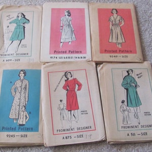 May include: Six vintage sewing patterns for dresses and coats. The patterns are printed on paper and feature illustrations of women wearing the garments. The patterns include sizes and designers' names.