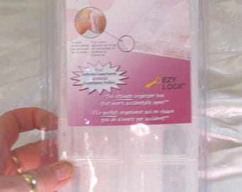 May include: Clear plastic Craft Mates locking caddy with 14 compartments. The caddy has a pink and white label with the text "Craft Mates" and "EZY LOCK". The caddy is designed to organize small items.