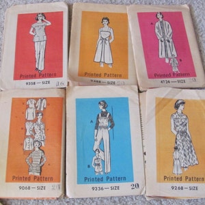 May include: A collection of vintage sewing patterns featuring illustrations of women's clothing designs. Each pattern packet has a colored background and includes the pattern number and size. The patterns depict dresses, jumpsuits, and other garments.