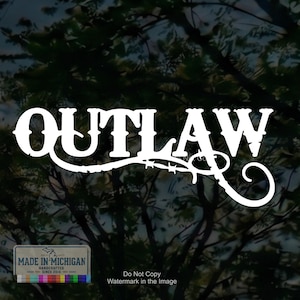 May include: A white vinyl decal featuring the word OUTLAW in a stylized western font. The letter W extends into a decorative flourish resembling a barbed wire strand. A small rectangular label in the corner reads MADE IN MICHIGAN HANDCRAFTED SINCE 2014.