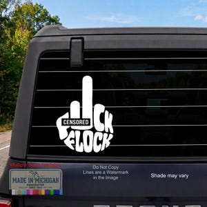 May include: A white vinyl decal applied to the rear window of a dark vehicle. The design features a stylized hand gesture with the middle finger raised, incorporating the text "CENSORED" and the word "FLOCK" in a bold, rounded white font.