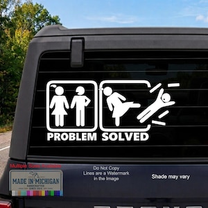 May include: A white vinyl decal applied to a vehicle rear window featuring two square icons. The first shows two stick figures standing together. The second shows one figure kicking the other. The text "PROBLEM SOLVED" is printed below the icons.