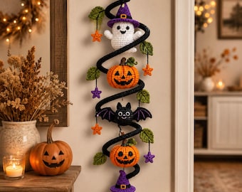 May include: A vertical crochet wall hanging featuring a black spiral base decorated with a white ghost in a purple hat, two orange jack-o'-lanterns, a black bat, green leaves, and small orange and purple stars, finished with a purple tassel.