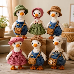 May include: Six crocheted goose dolls with white bodies and orange beaks. They wear various outfits including blue overalls with brown satchels, a green dress, a pink dress, and hats in green, pink, brown, and tan. Each doll has black bead eyes.