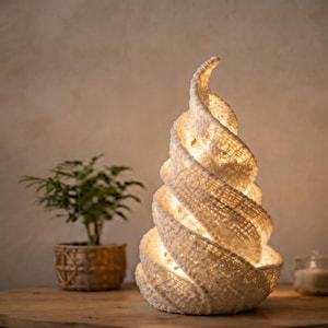 May include: A spiral-shaped table lamp with a textured, off-white woven exterior. The lamp emits a warm, soft glow from within its hollow, conical structure, which features a distinct swirling pattern that tapers to a point at the top.