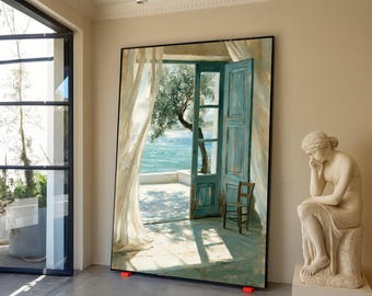 May include: A large rectangular framed painting depicting an open doorway leading to a sunlit terrace overlooking the sea. The scene features a blue wooden door, a wooden chair, sheer white curtains, and an olive tree under a bright sky.