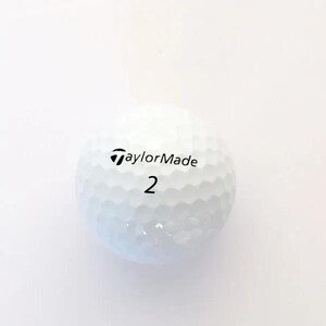 May include: A white golf ball with a dimpled surface texture. The ball features the black text TaylorMade printed above the number 2 in a black font. The design is spherical and consistent with standard equipment used for playing the sport of golf.