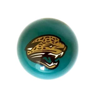 May include: A smooth, spherical object with a teal background featuring a centered graphic of a jaguar head in profile. The jaguar is depicted in shades of gold, black, and white, showing an open mouth with visible teeth and spotted fur.