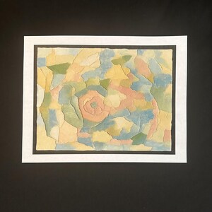 May include: A rectangular artwork featuring a mosaic-like composition of irregular, interlocking paper shapes in soft pastel shades of peach, pale blue, sage green, and cream, arranged within a black border and a white outer frame.