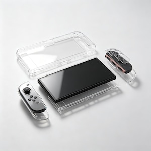 May include: A handheld gaming console with a black screen and two detachable controllers, accompanied by a set of clear, transparent protective plastic shells designed to fit the main console body and each individual controller component.