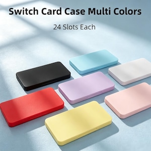 May include: A collection of rectangular game card cases in black, red, yellow, light blue, purple, white, and pink. Each case features 24 slots for storage. The text Switch Card Case Multi Colors and 24 Slots Each is visible at the top.