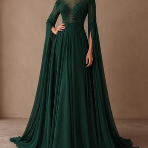 May include: A floor-length dark emerald green gown featuring long split sleeves and a sheer illusion neckline. The bodice is adorned with intricate beadwork and embroidery that extends from the shoulders down to the waist, transitioning into a flowing skirt.