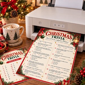 May include: A printed Christmas trivia game sheet and an answer key featuring festive red and green holiday graphics, including ornaments, pine branches, and a lantern. The text includes fifteen multiple-choice questions about Christmas movies and songs.