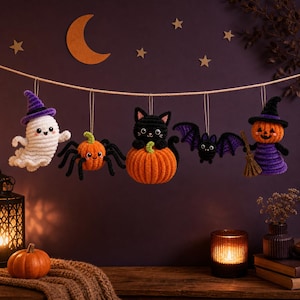 May include: A crochet garland featuring five hanging ornaments: a white ghost in a purple hat, an orange pumpkin spider, a black cat sitting on an orange pumpkin, a black bat with purple wings, and an orange pumpkin character in a purple hat.