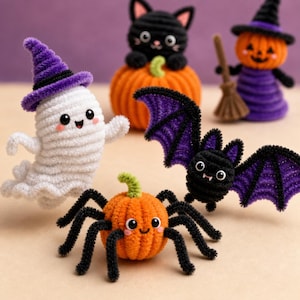 May include: A collection of five small crocheted Halloween figures including a white ghost with a purple hat, a black cat on an orange pumpkin, a witch with a broom, a black and purple bat, and an orange pumpkin spider with black legs.