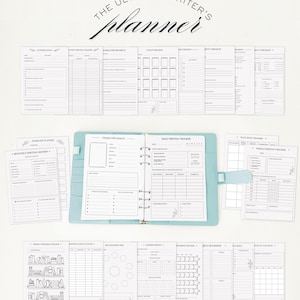 May include: A light blue ring-bound planner open to a daily writing tracker page, surrounded by various loose-leaf planning sheets. The text "THE ULTIMATE WRITER'S planner" is centred at the top. The pages feature grids, lists, and prompts.