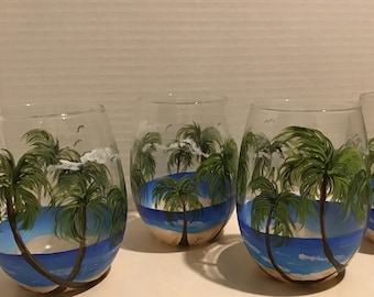 Beach, palm trees, water painted on stemless wine glasses. Hand painted.