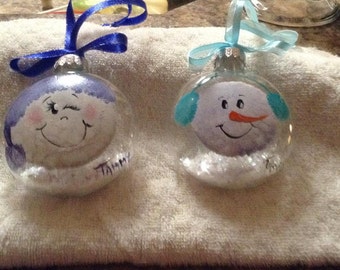 Handpainted snowmen ornaments with beautiful detailed faces and coordinating ribbon hangers.