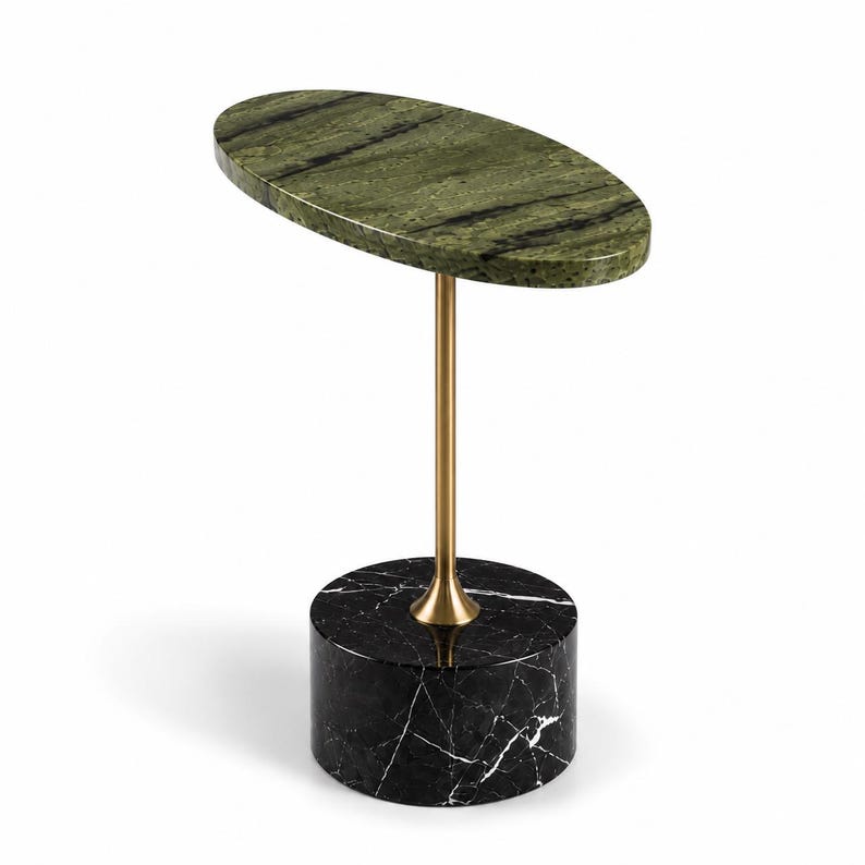 May include: An oval side table featuring a green marble top with dark veining, supported by a slender gold-toned metal pedestal base that connects to a cylindrical black marble base with white veining, creating a tiered, multi-material structure.