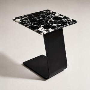 Luxury marble side table styled beside a modern sofa with coffee cup and decorative vase, natural marble accent table for living room, contemporary C-shaped end table, premium handmade marble furniture.