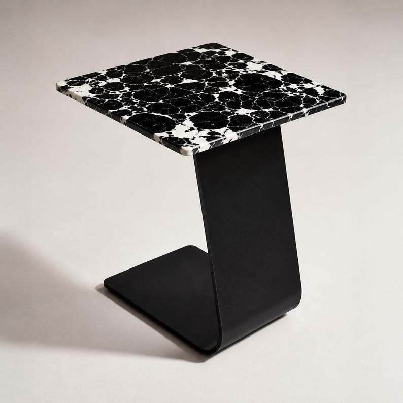 Luxury marble side table styled beside a modern sofa with coffee cup and decorative vase, natural marble accent table for living room, contemporary C-shaped end table, premium handmade marble furniture.
