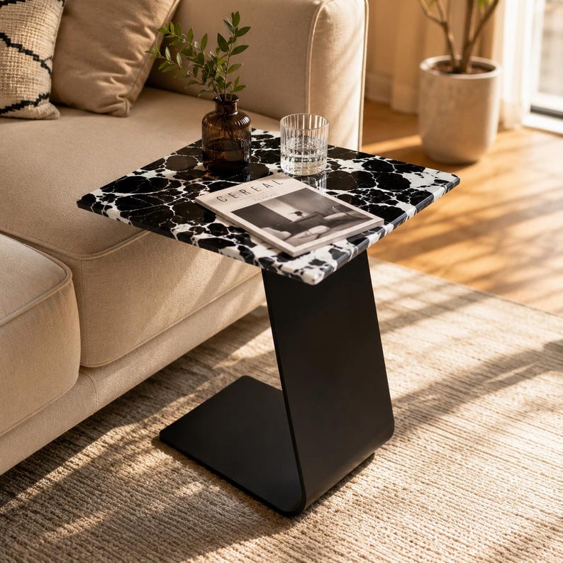 Luxury marble C-shaped side table with natural black and white marble top and matte black metal base, modern sofa side table for living room, premium marble coffee table, handmade stone accent table, contemporary end table for luxury home décor.