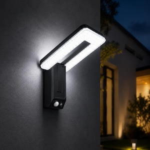 May include: A black rectangular outdoor wall light fixture with a U-shaped LED panel that emits a bright white glow. The base of the unit features a small circular motion sensor and a secondary sensor component, mounted vertically on a dark wall.